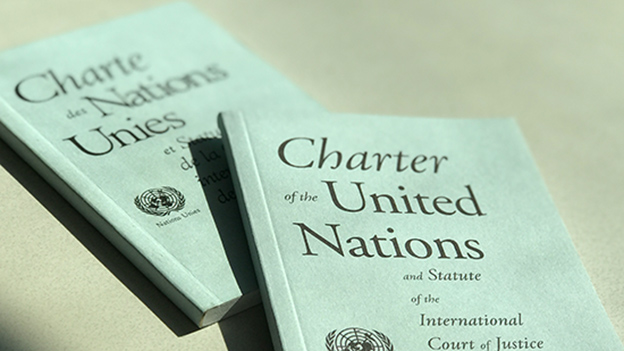 Photo of two copies of UN Charter, one in English, one in French.